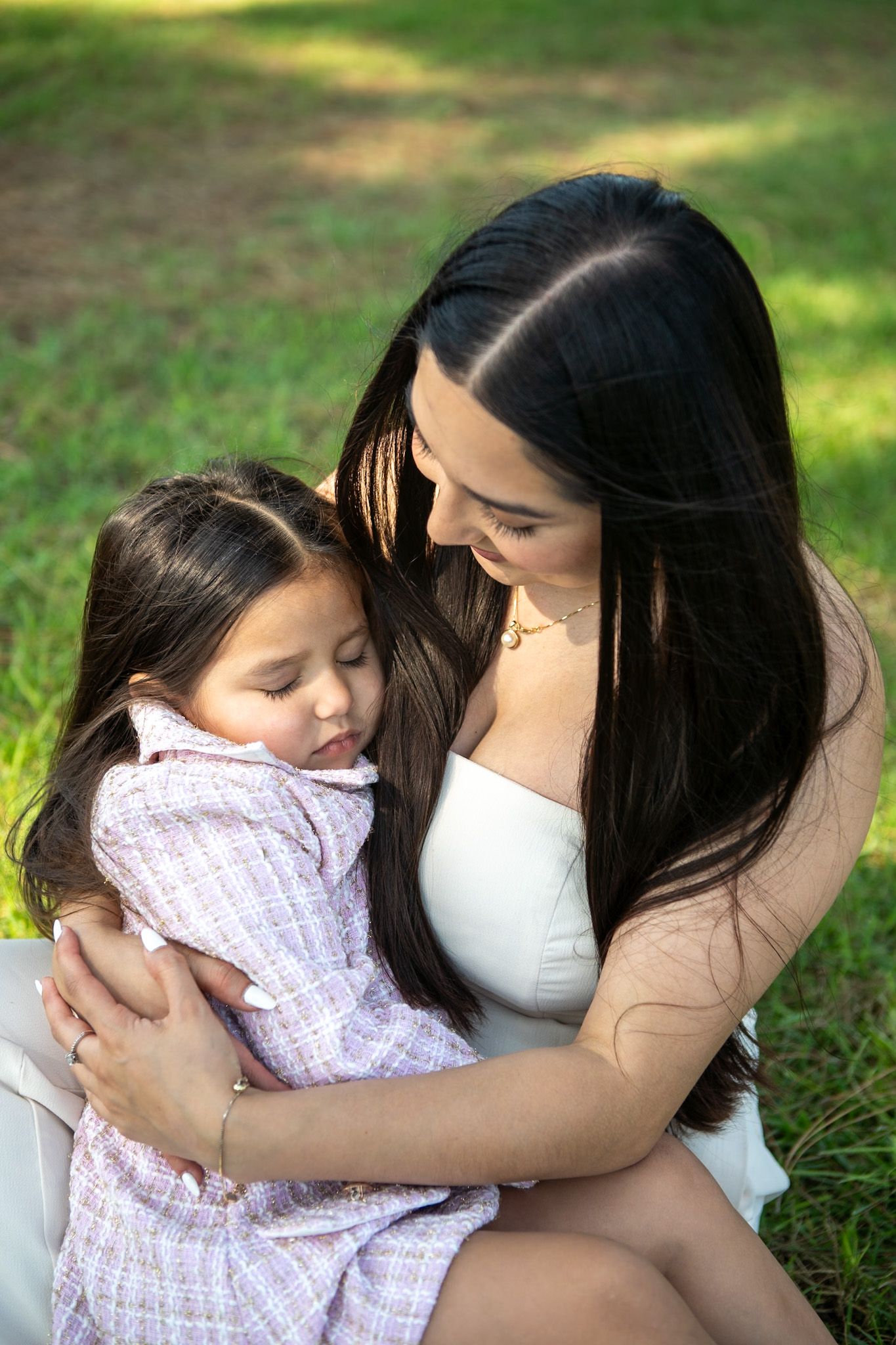 Emotional outdoor photography sequence capturing intimate bonding moments between two people in a grassy park.