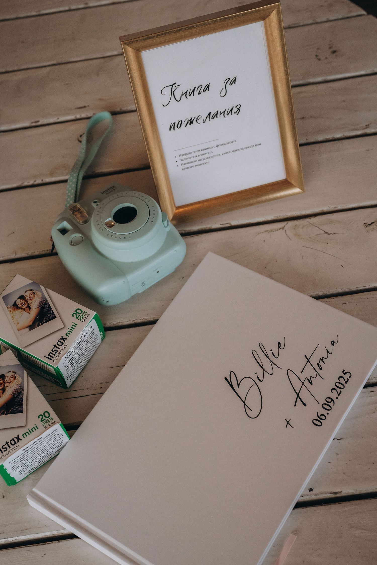 Wedding guest book for Billie and Antonia dated 06.09.2023 with Instax mini camera and film.