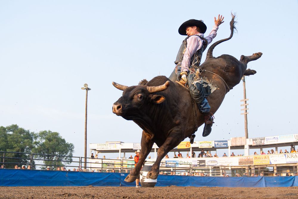 Bull rider riding a bull at an amateur rodeo
