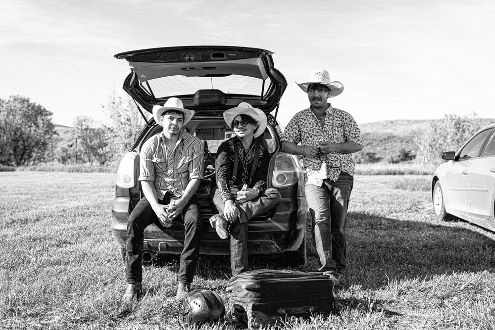 Rodeo Cowboys hanging out before an amateur rodeo