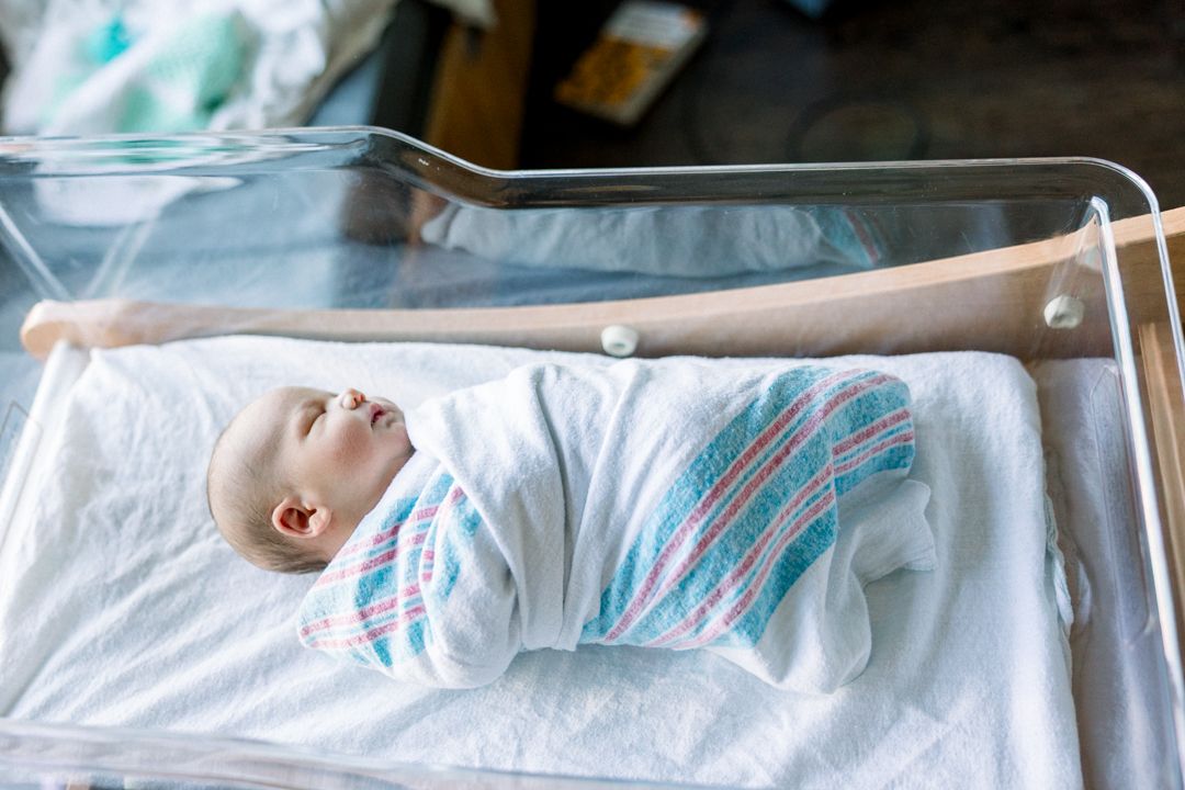 Soft natural light on newborn baby during hospital session in Augusta Georgia