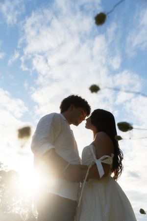 Romantic couple in silhouette sharing an intimate moment at sunset. Flower field located in Connecticut