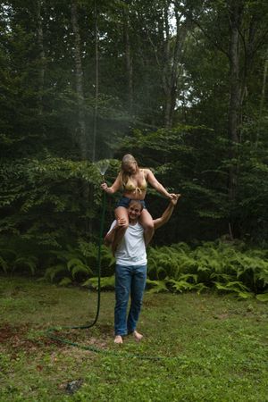 couples prompts and poses for an outdoor creative rain session with a garden hose