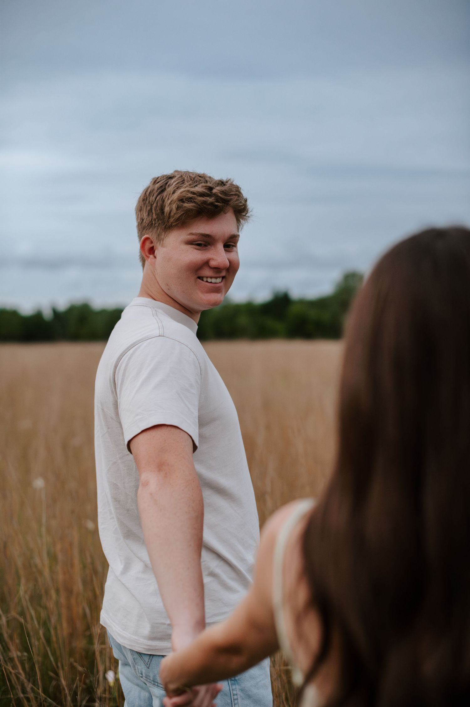 Wichita KS outdoor engagement photos in nature location Andover, couple photos in field with flowers, small elopement wedding photographer