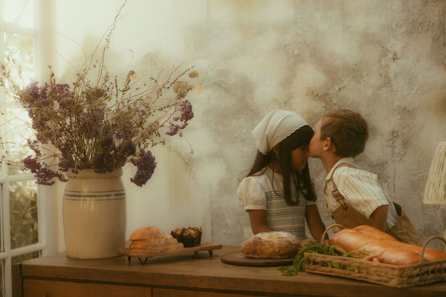 Two children share a tender moment at a rustic wooden table with breads, captured by an Orange County family photographer.