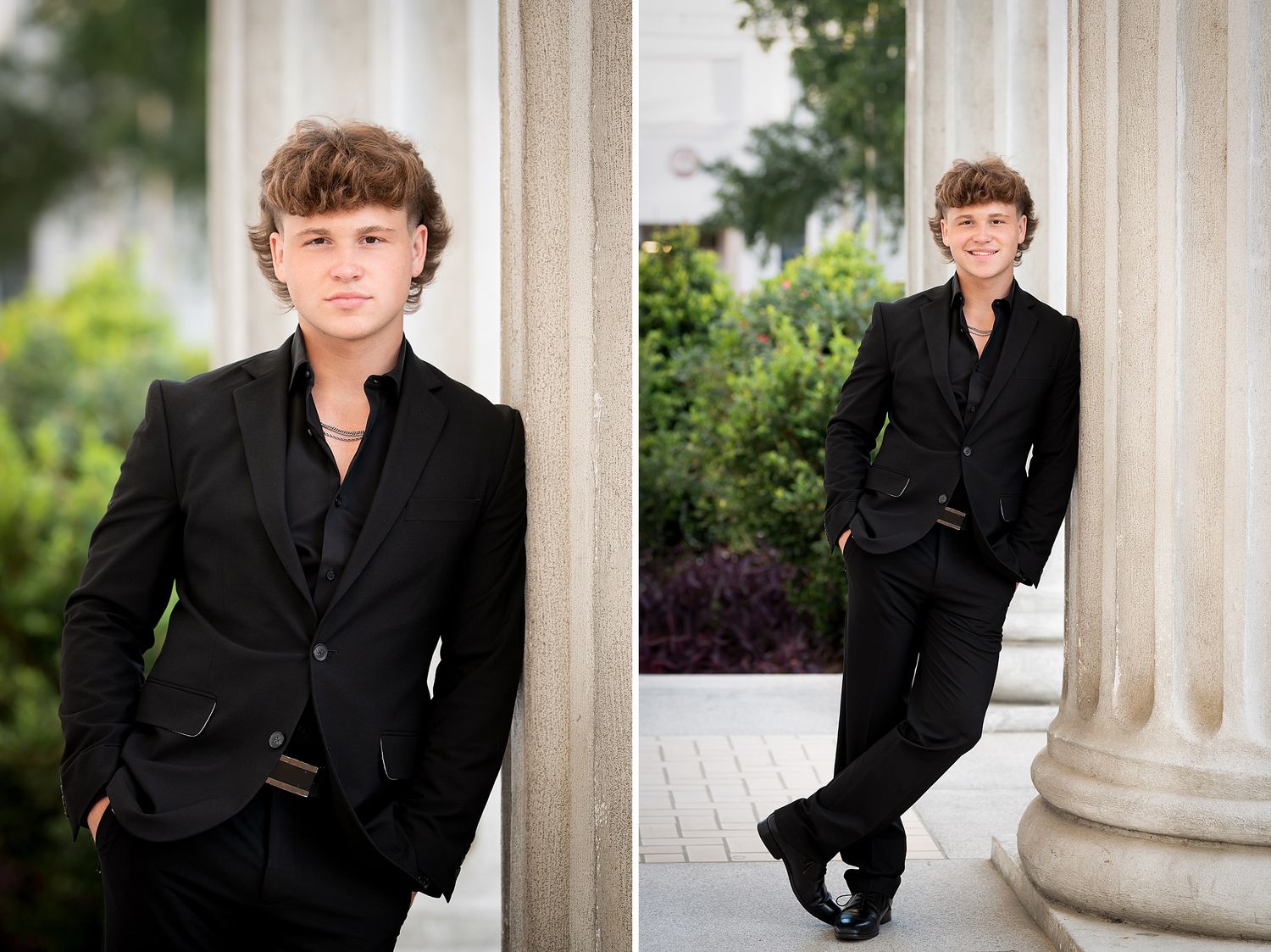 Teen boy in black suit posing confidently by white columns outdoors for senior portrait photography.