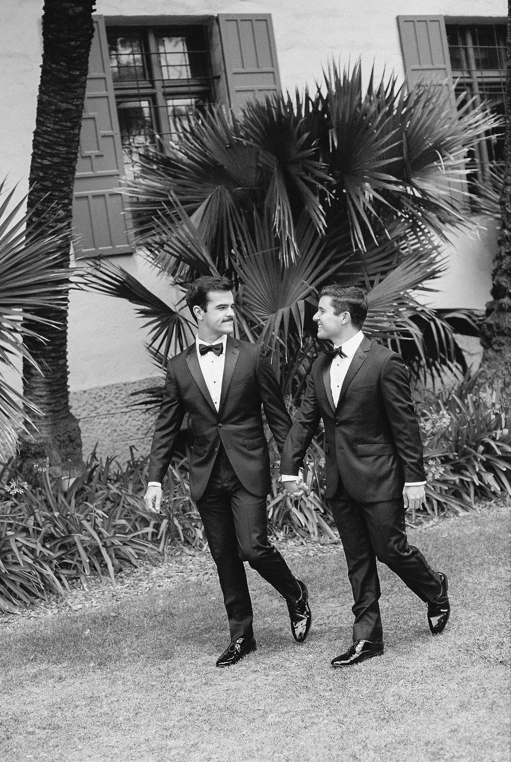 Blurry motion portrait of a modern queer couple celebrating their courthouse elopement exit in California.