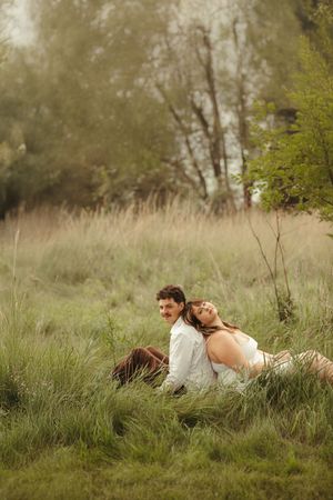 Intimate portrait of a couple in love with lush green background, soft light and timeless styling.