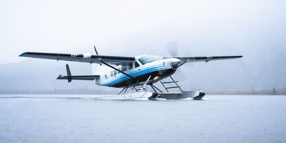Row of seaplanes parked on snowy terrain during winter conditions.