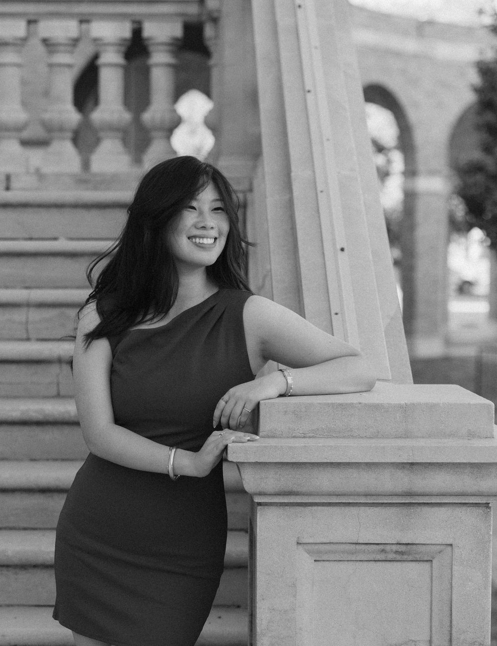 A series of black and white portraits showing joyful moments against a classical architectural backdrop.
