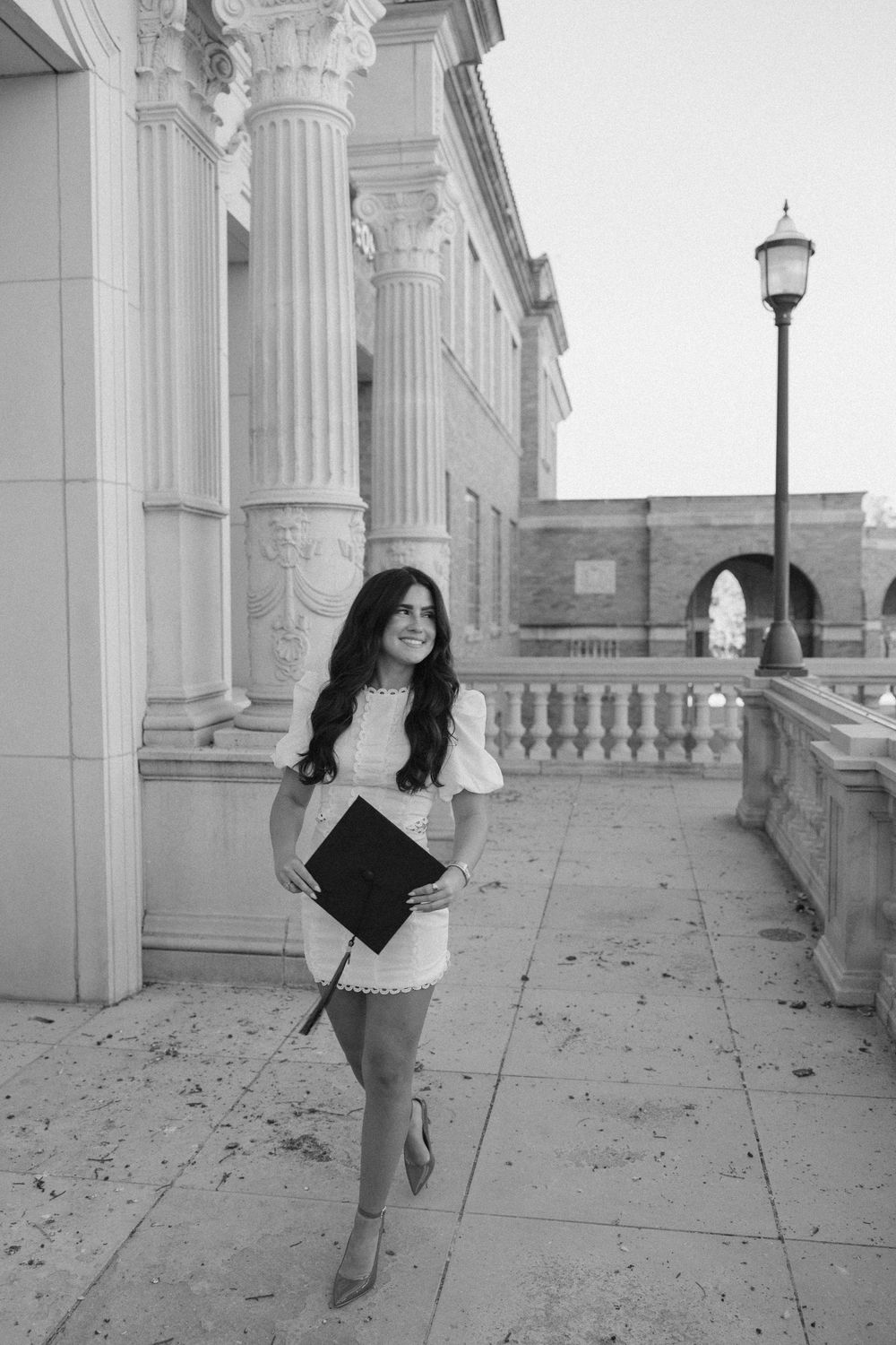 A series of black and white photos showing someone posing in a classical colonnade with ornate architectural details.