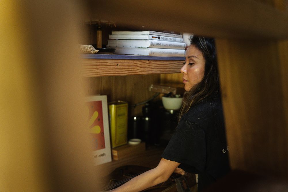 Creative entrepreneur reading in a wooden home interior during a branding session.