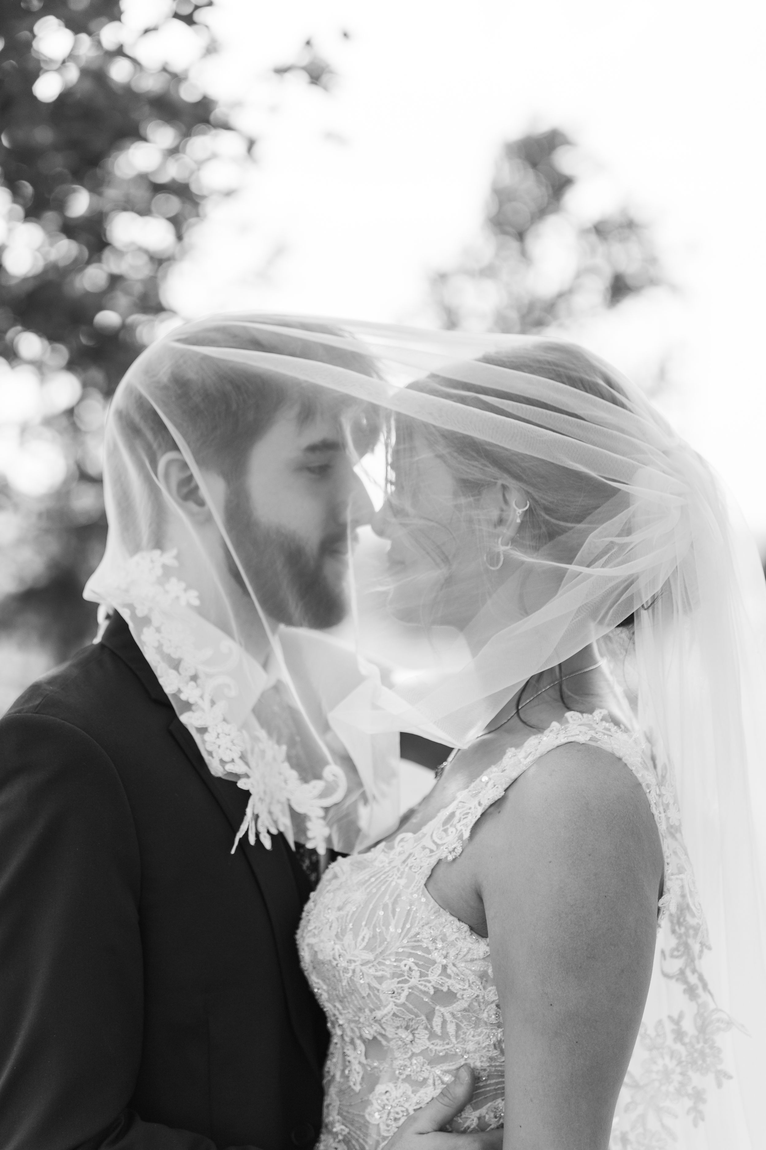 A romantic black and white wedding photo sequence shows a couple sharing intimate moments under a flowing veil.