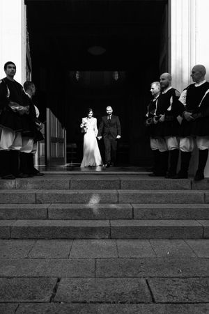 Black and white sequence of wedding ceremony moments on grand building steps.
