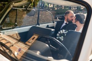 View through car window of wedding transportation details.
