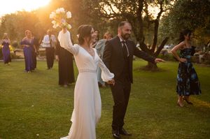 Wedding celebration in outdoor garden setting during sunset.