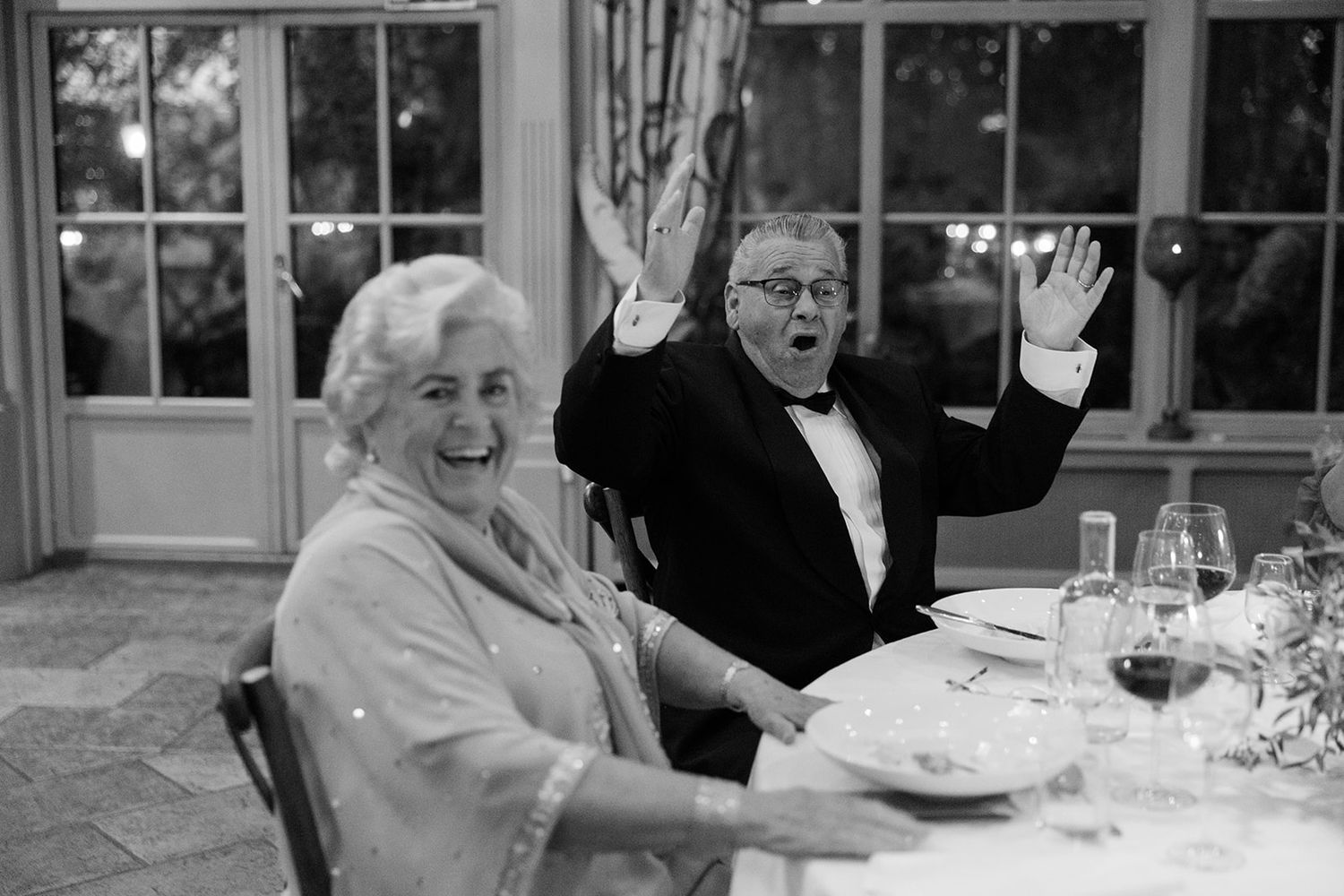 People enjoying a meal and conversation together at a formal dining event.