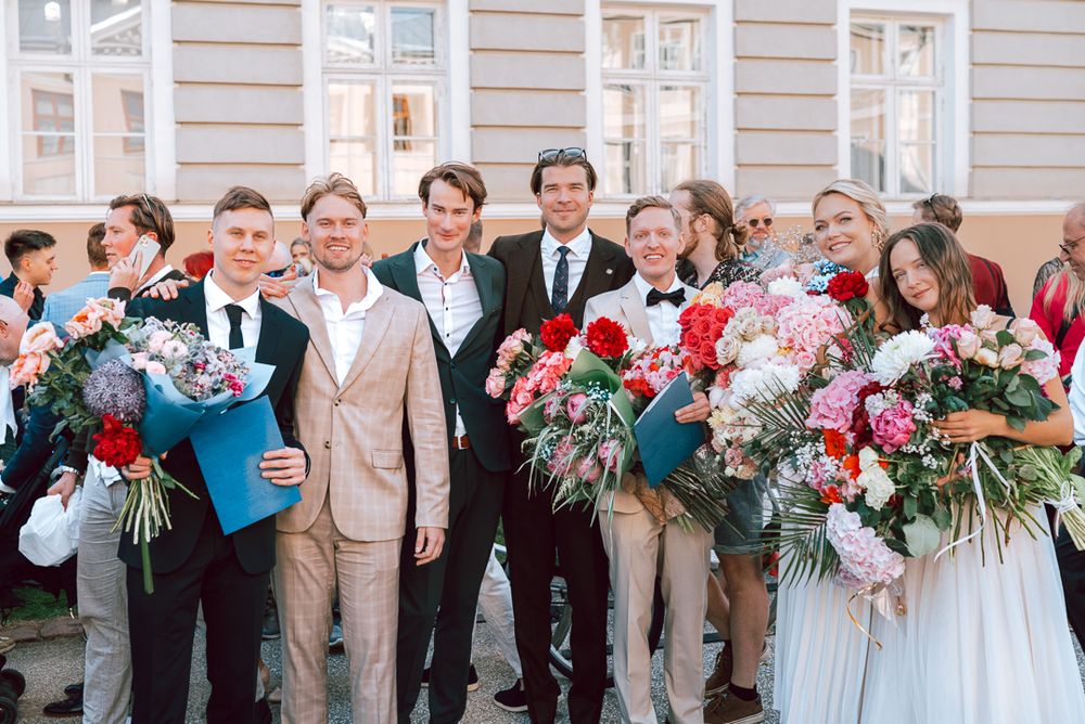 A series of wedding party photos showing guests and wedding party members holding bouquets outside a light colored building.