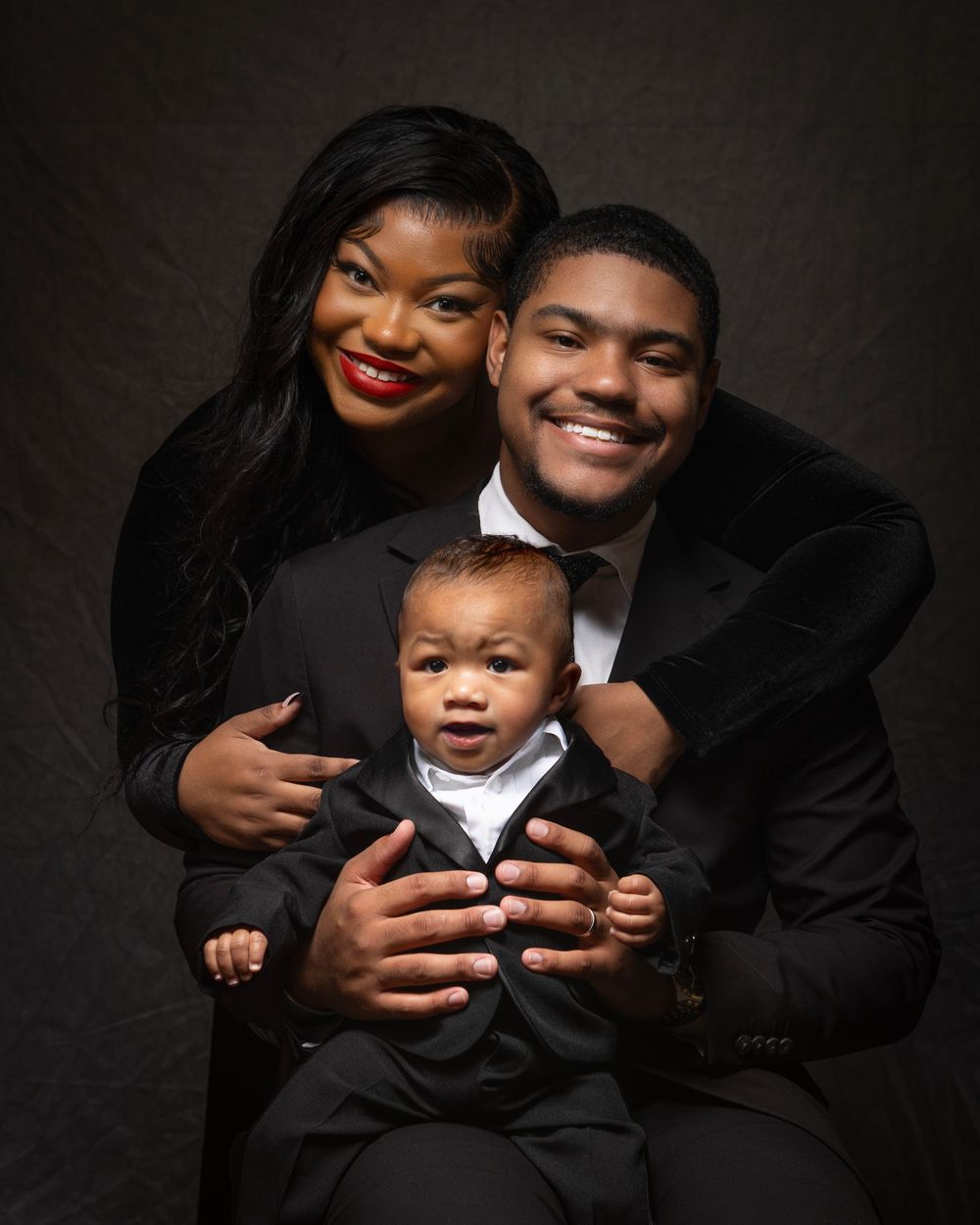 Formal portrait series of a family in black attire against dark background.