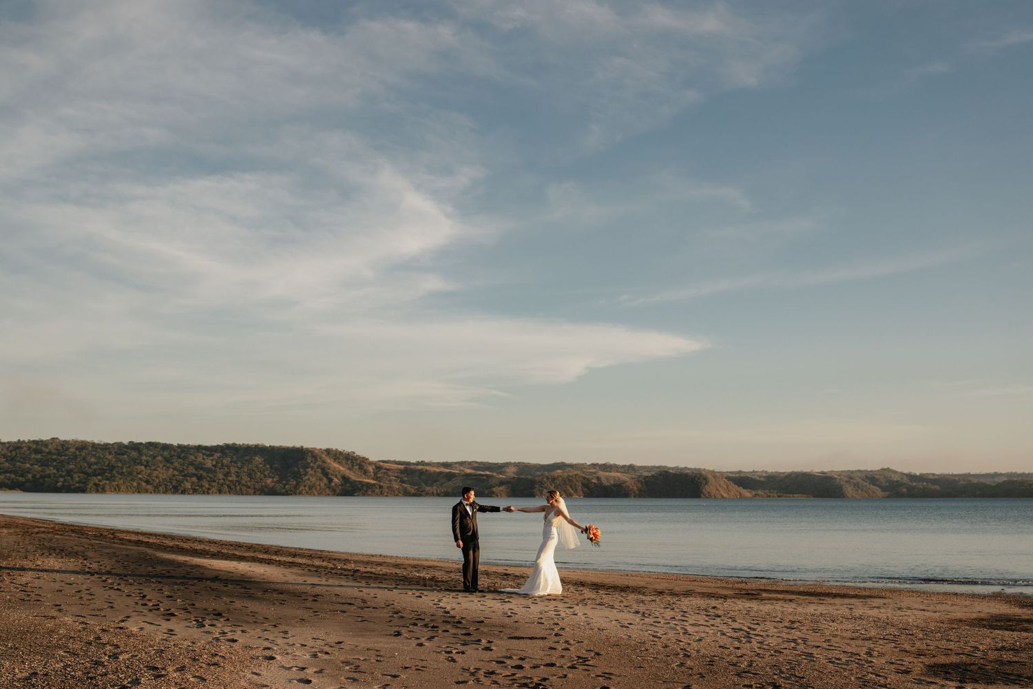 Couple dancing joyfully on a beach during their Costa Rica elopement.