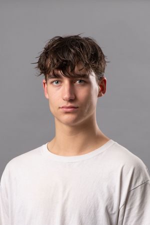 A series of profile views showing someone wearing a white t-shirt against a gray background.