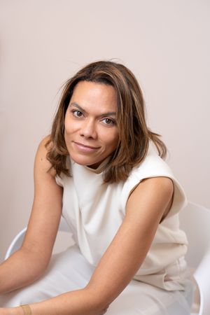 A series of minimalist studio portraits featuring a person in a sleeveless white top against a light background.