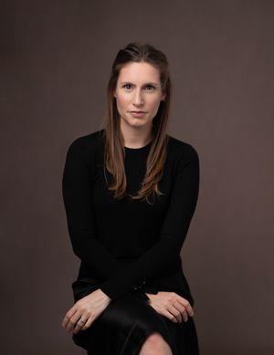 Studio portrait series showing person in black sweater against dark background in various contemplative poses.