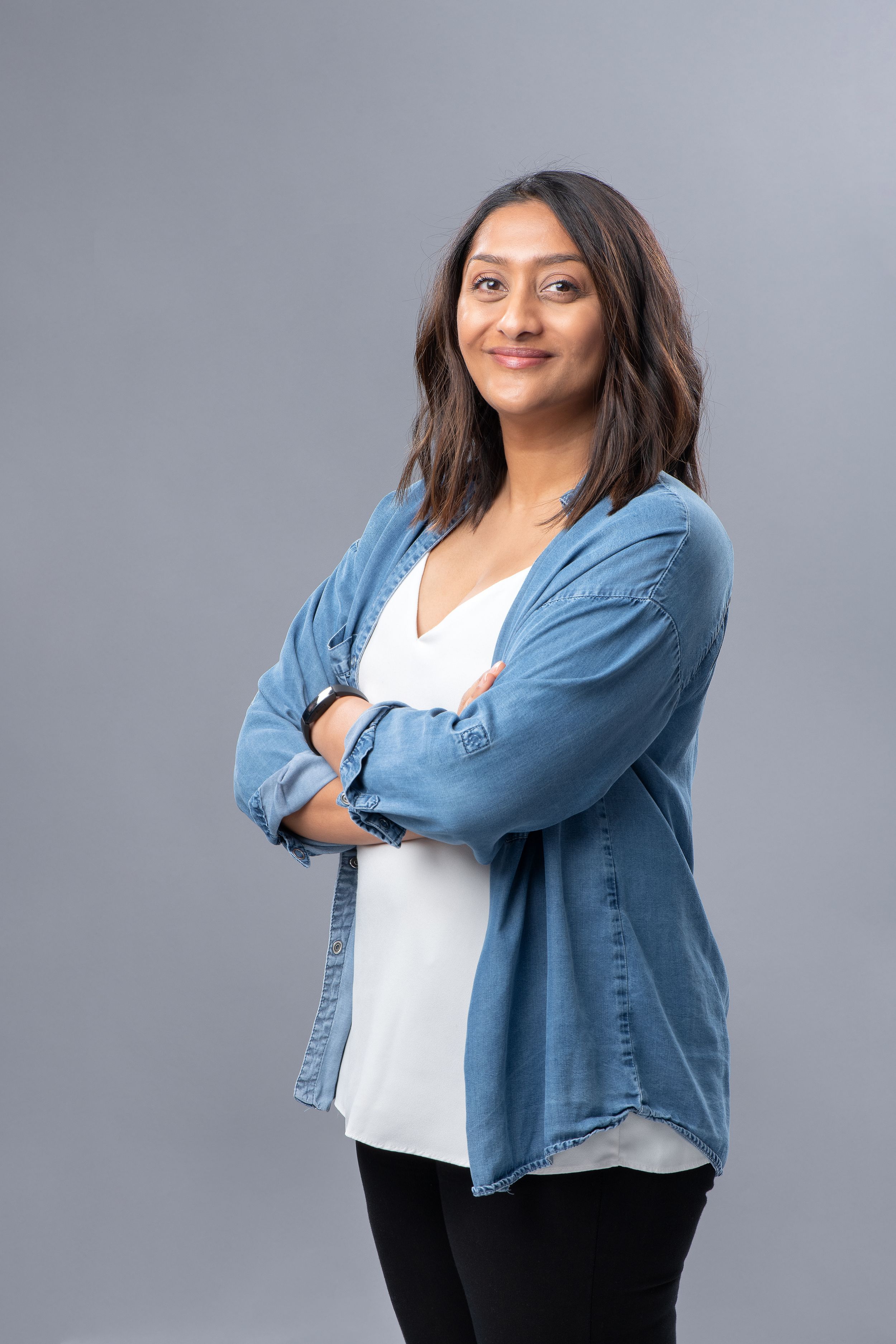 Professional headshot series showing person in denim jacket and white top posing confidently against gray background.