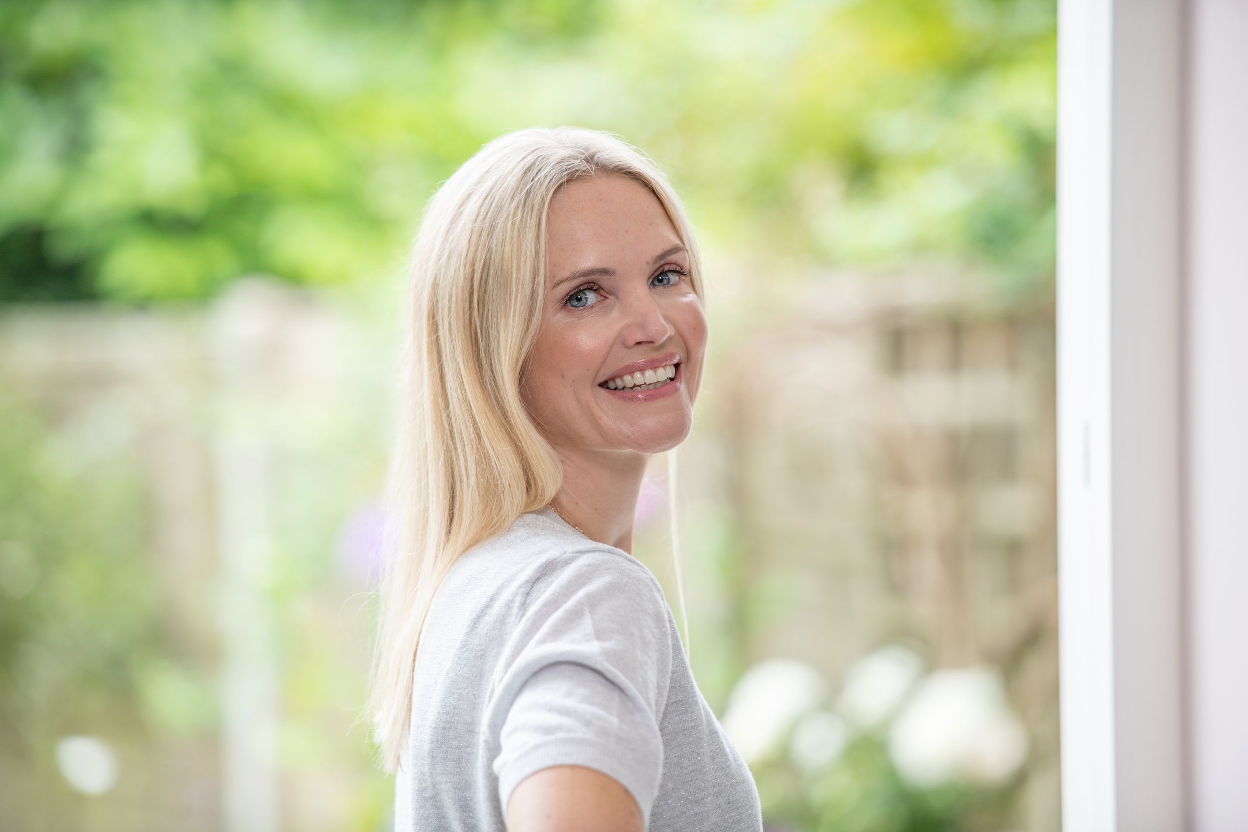 A series of outdoor portrait photos showing a person with blonde hair wearing a white top against a blurred natural background.