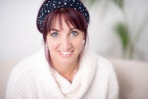 Four headshots of someone wearing a polka dot headband and white sweater against a light background.