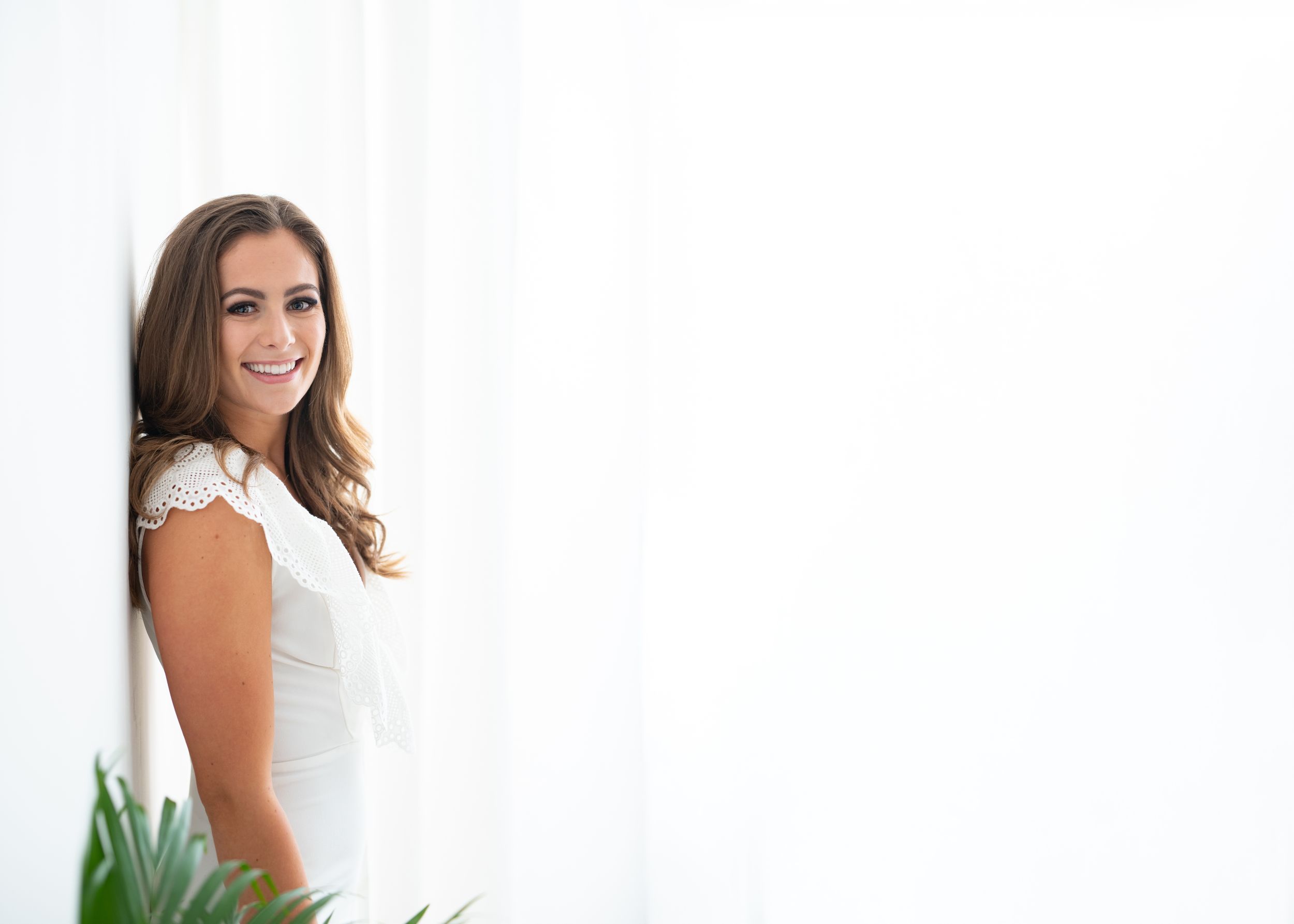 A bride in a white wedding dress poses elegantly against a white background in a series of four photos.