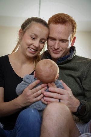 Candid photos of parents sharing joyful moments with their newborn baby.