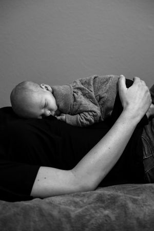Black and white photo series of sleeping baby resting peacefully on soft surface.