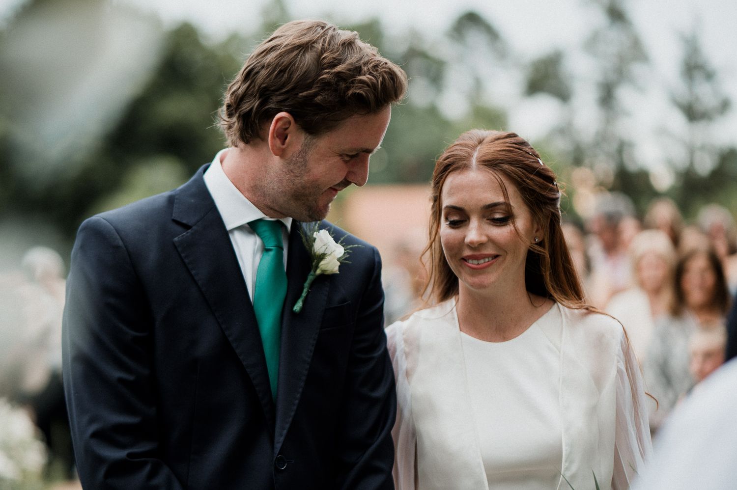 Intimate moment between newlyweds during their outdoor garden wedding ceremony.