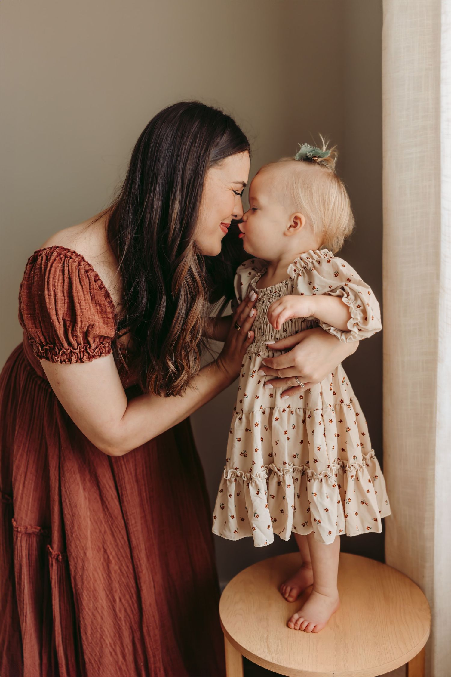 Mom and one-year-old girl nose-to-nose as the baby reaches for kisses during a Maryville, TN studio session