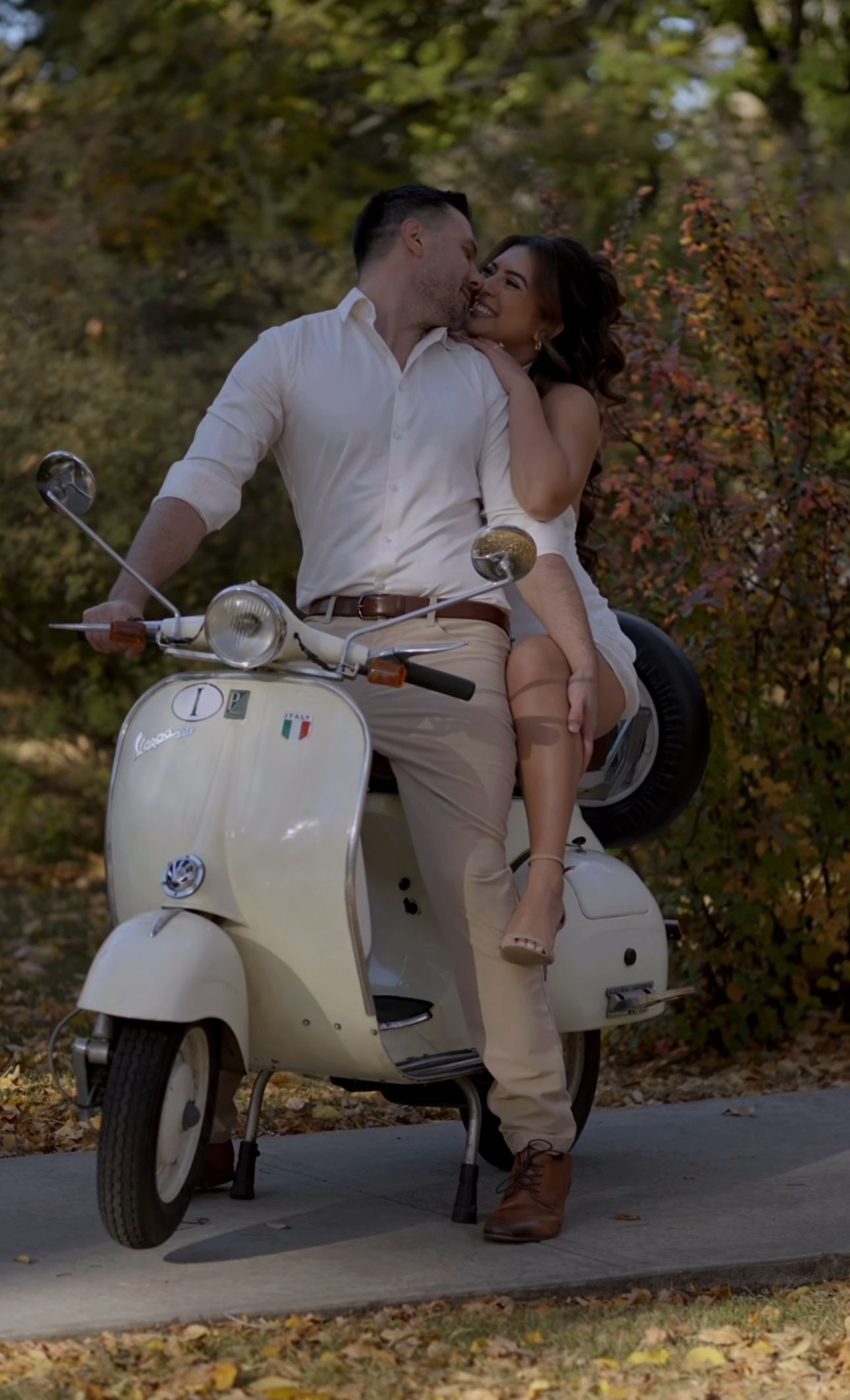A couple shares an intimate moment in a limousine after their wedding ceremony.