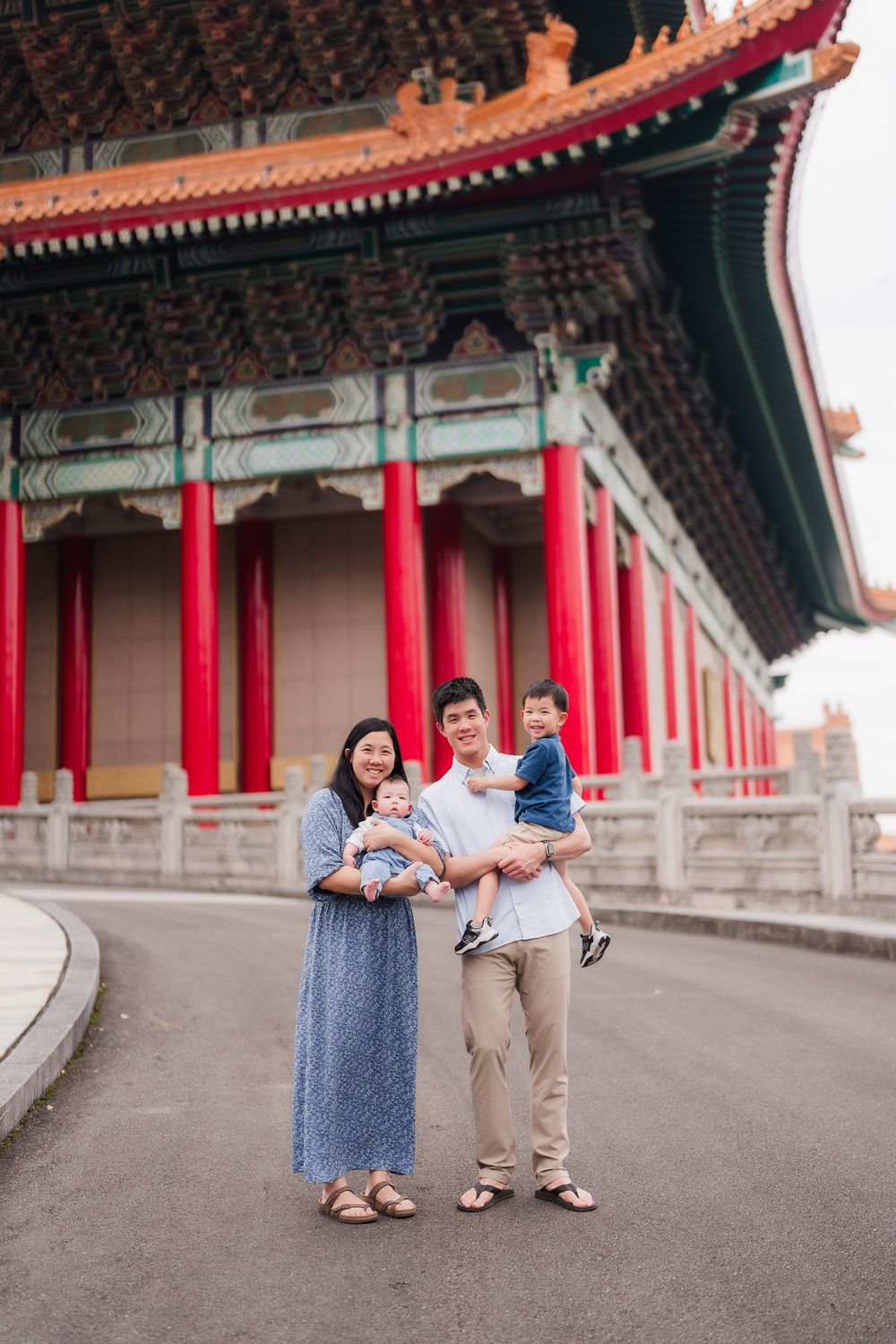 Family portrait near the iconic red pillars of Taipei National Theater and Concert Hall at Chiang Kai Shek Memorial Hall.