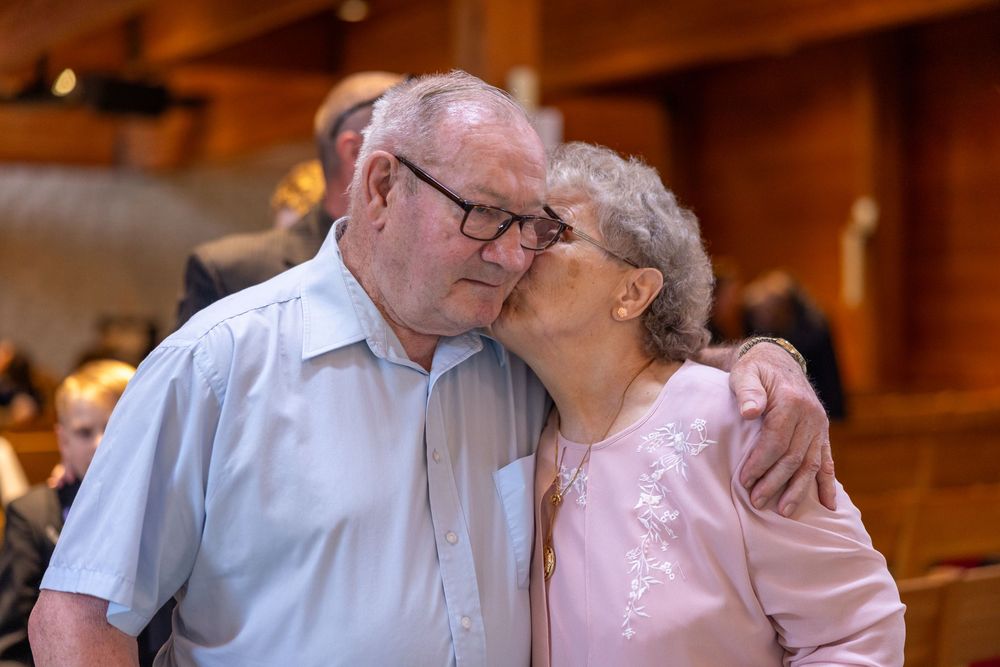A romantic series of photos showing a tender moment between an elderly couple sharing kisses and embraces.