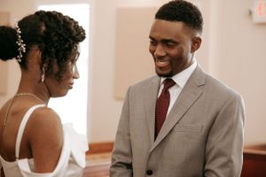 Couple shares joyful moment during wedding ceremony.