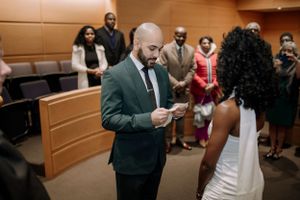 Intimate courthouse wedding ceremony with couple exchanging vows in a formal setting.