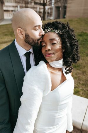 An intimate moment between a couple in formal attire with a soft, romantic pose.
