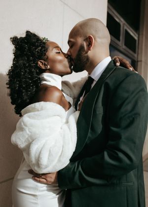 A romantic moment captured between a couple in elegant wedding attire.