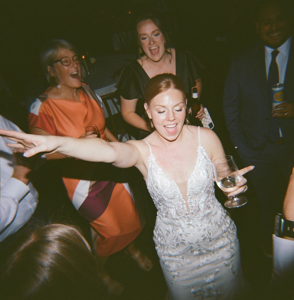 Joyful dancing moment captured during wedding reception celebrations.