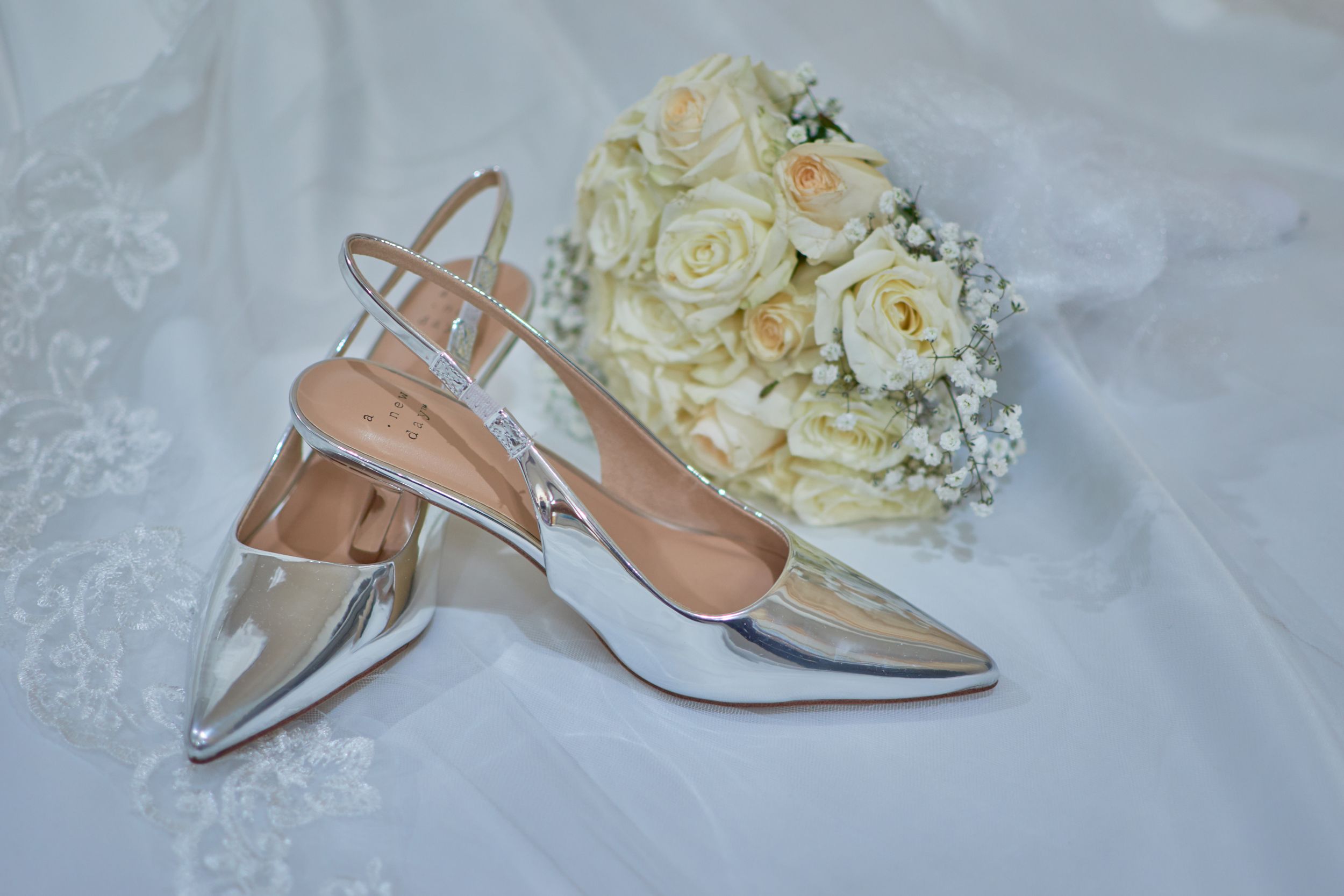 Sliver shoes and White Roses on Brides Dress.