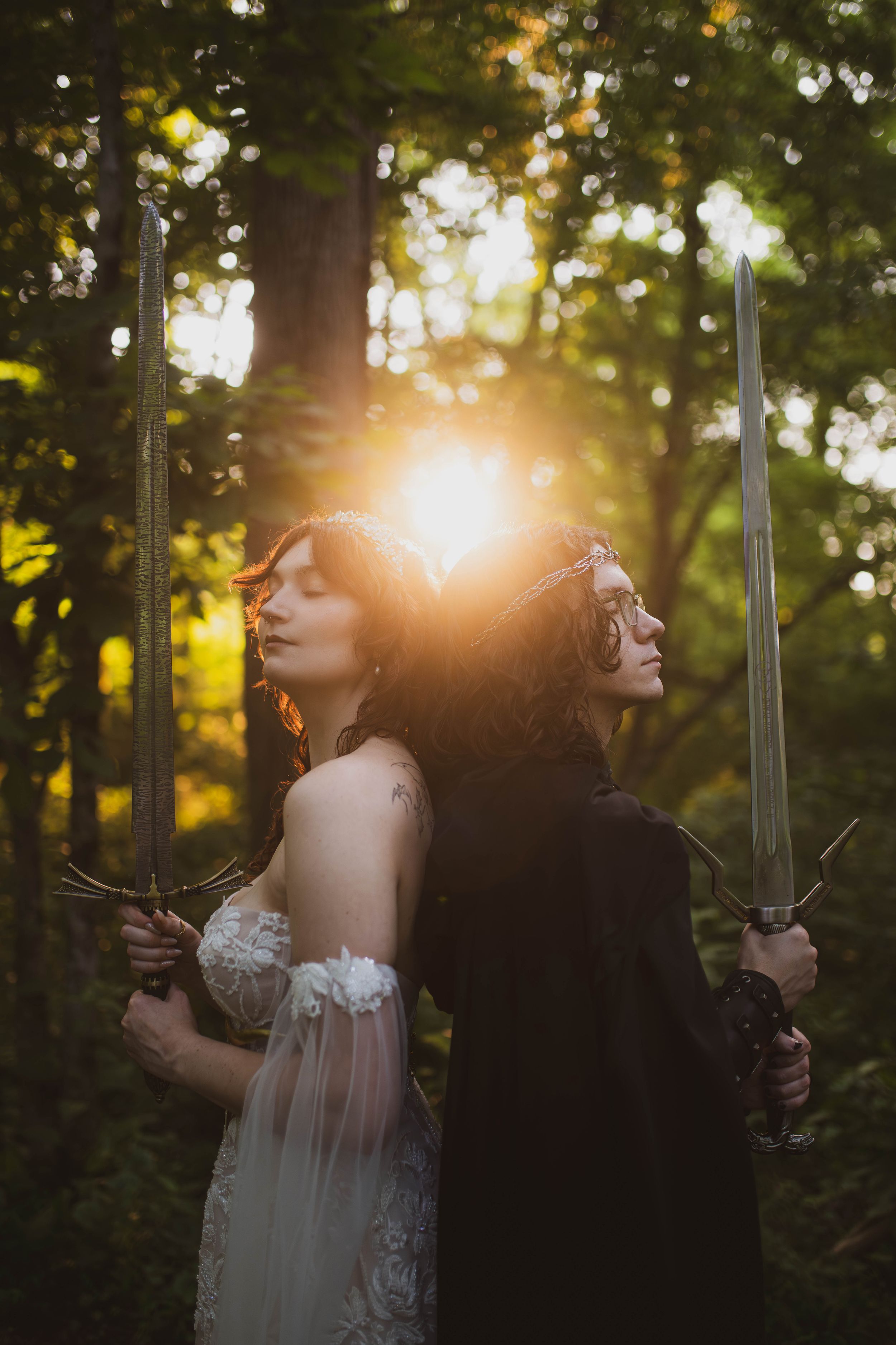 A romantic sunset moment between wedding couple embracing in a lush forest setting with golden light filtering through trees.