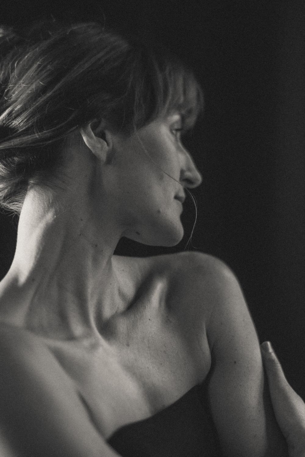 Intimate black and white portrait showing expressive movement and emotion.