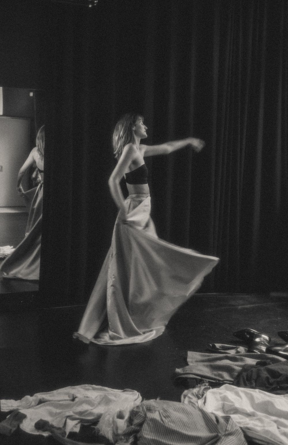 Dynamic dance movement captured in black and white with swirling cream fabric.