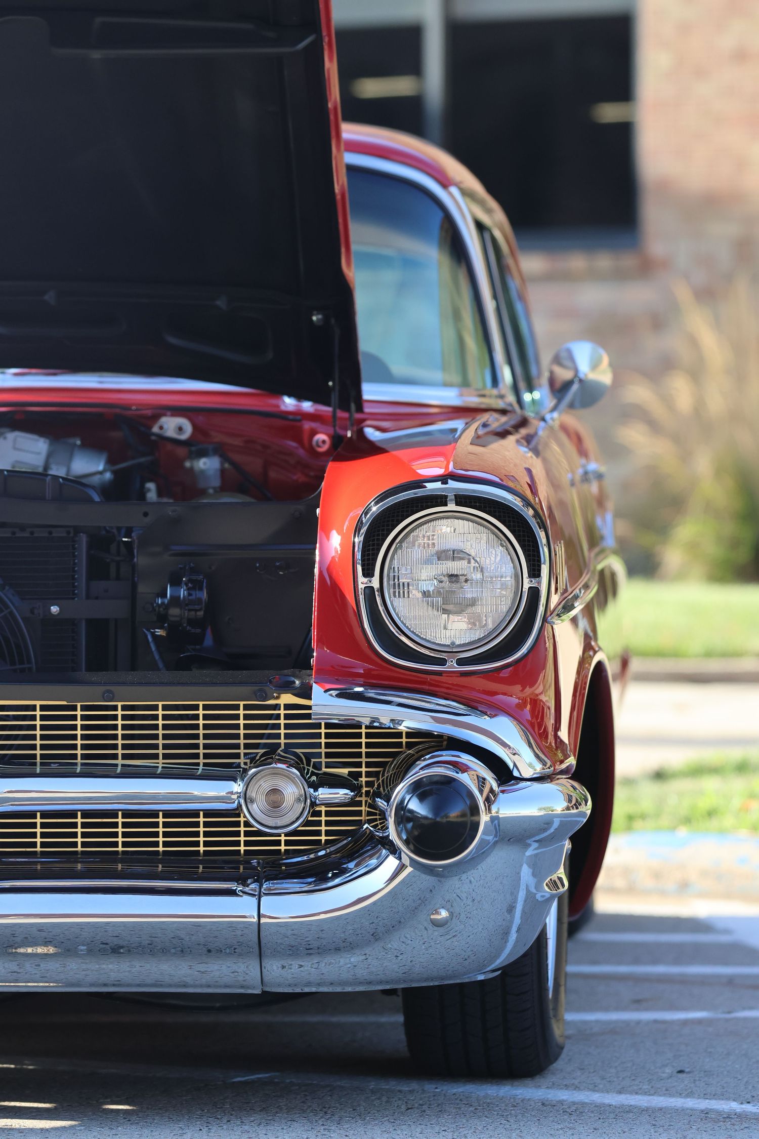 Front quarter view of a classic 1957 Chevrolet Bel Air in red and black.