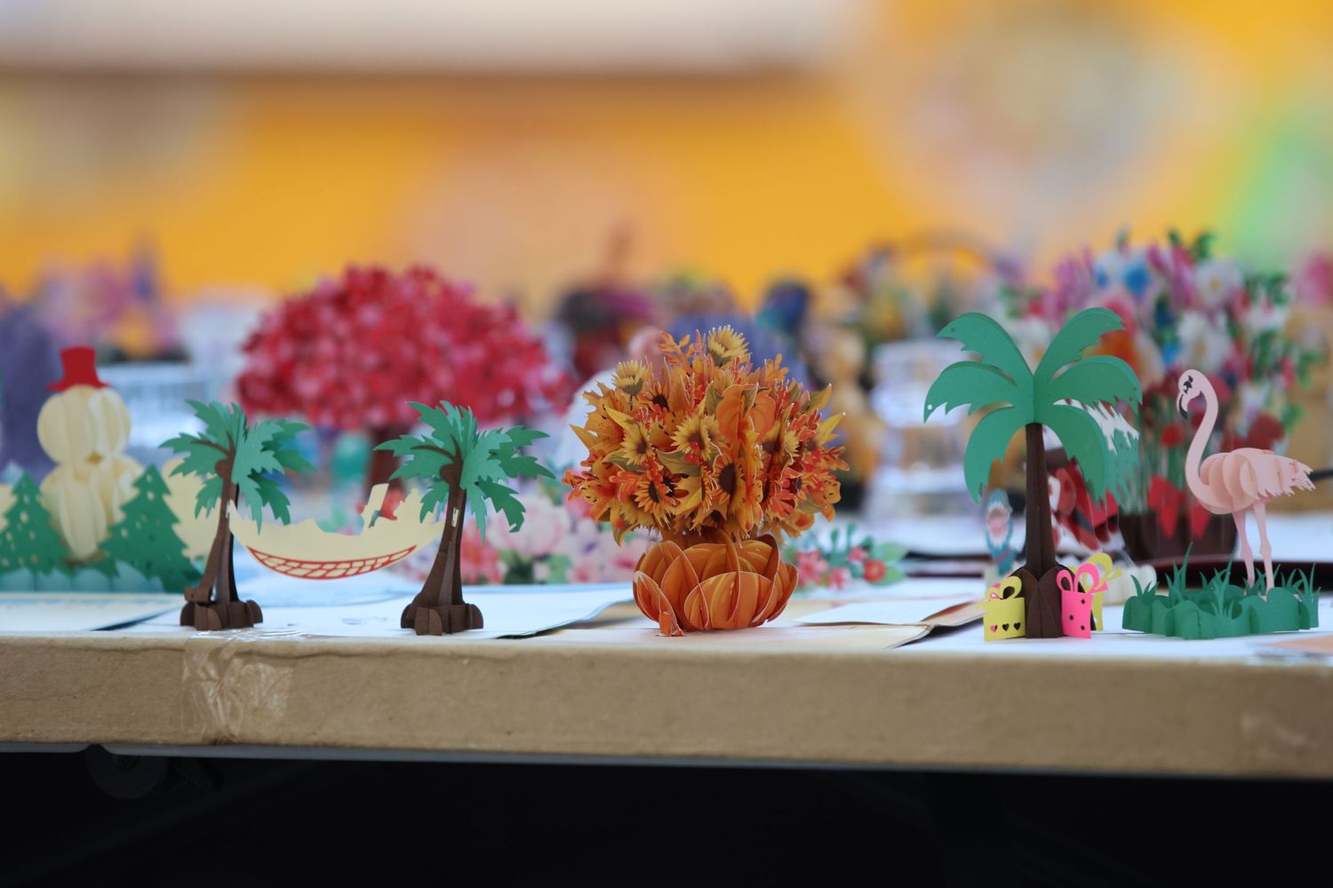Decorative miniature palm trees and flamingos on display at a table setting.