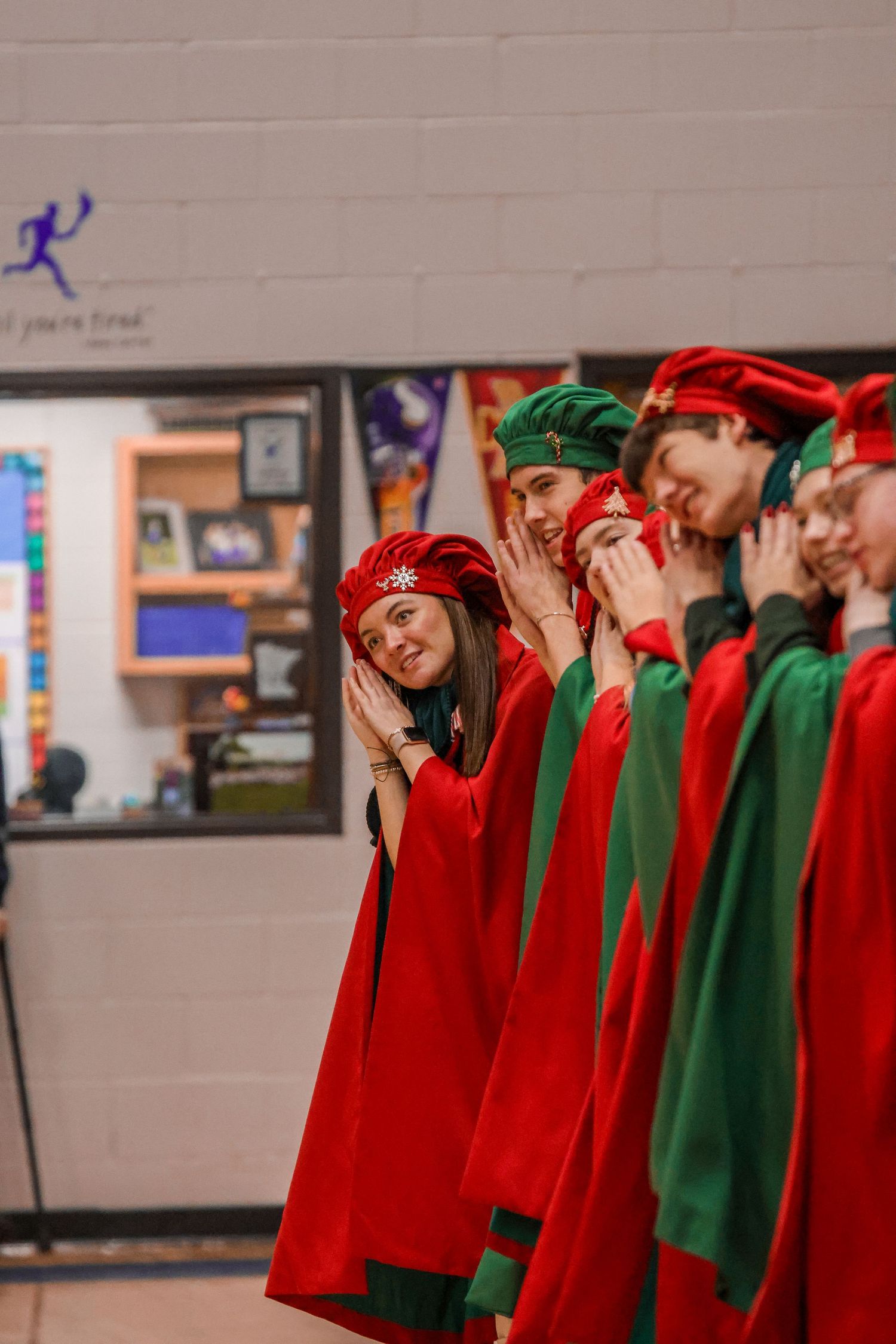Holiday performers in festive red and green costumes lined up during a show.